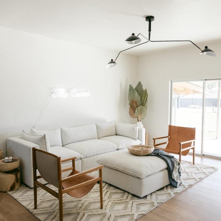 white sofa near brown wooden chair
